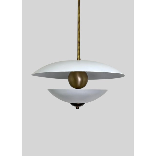 Add a touch of timeless elegance to your living space with this stunning pearl-look brass pendant light. The delicate...