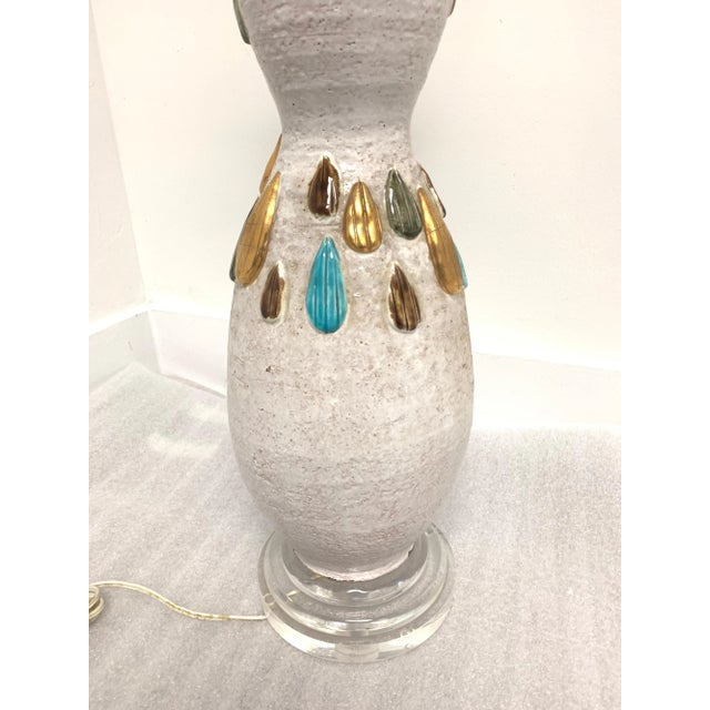 Tall glazed earthenware lamp with tear drop relief in jewel tones.