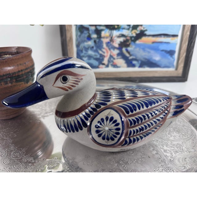 A charming hand-painted duck from Tonalá, Jalisco, Mexico. Cream-speckled clay is decorated with cobalt blue and warm...