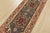 A traditional tribal Heriz runner hand-knotted with an all-wool pile on a cotton foundation. This oriental rug features...