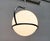 Elegant space age pendant lamp of italian origin. an impressive yet simple design. A large glass ball is held in an...