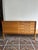 Beautiful minimalist sideboard in a warm wood tone. This unique piece of furniture consists of two cabinet elements...