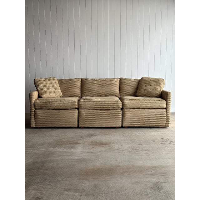 Vintage three-piece modular sectional sofa with squared arms and a low, grounded profile. Patterned upholstery in a warm...