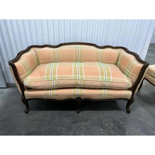 Offered is a vintage settee/loveseat with coordinating ottoman by Baker Furniture. This loveseat features a removable...