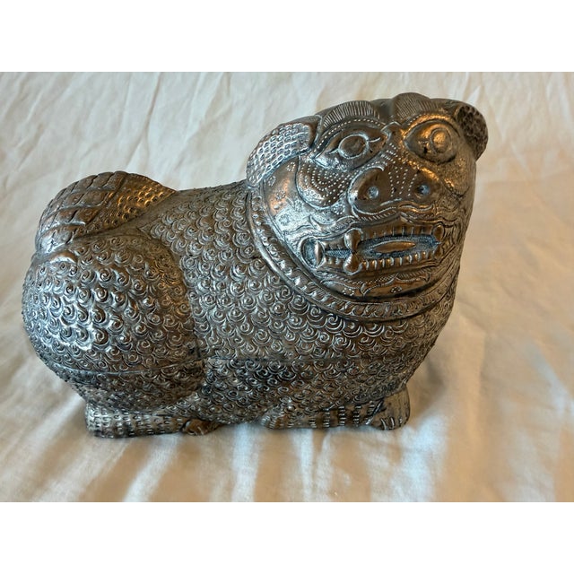 Large antique Cambodian silver-plated foo dog/lion featuring engraved surface details and sculptural ornamentation. The...