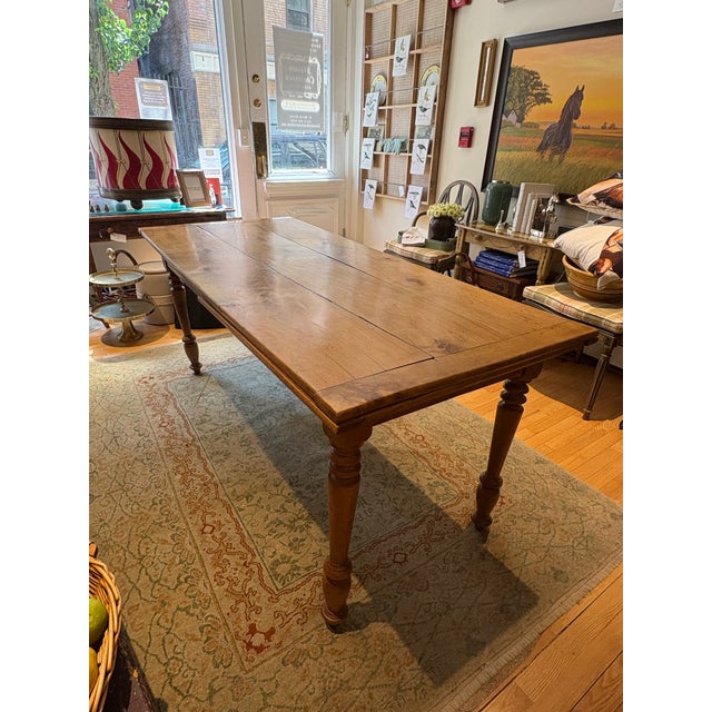 This is an antique farmhouse table. It is maple wood. The wood is warm and worn given its age. It can seat eight people....