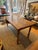 This is an antique farmhouse table. It is maple wood. The wood is warm and worn given its age. It can seat eight people....