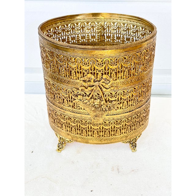 Elevate your space with this fabulous vintage mid-century Hollywood Regency-style footed wastebasket. Crafted with an...
