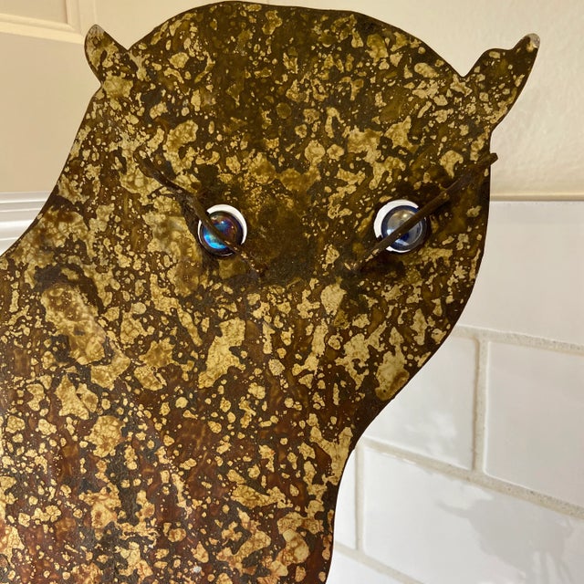 This metal sculpture is a moody interpretation of an owl. Styled after artist Curtis Jere and made in Thailand. He sits on...