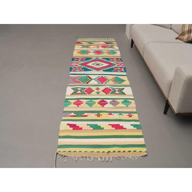 Vintage Hand-Knotted runner rug is a semi-antique vintage area rug. The '70s Eastern region of Anatolia's unique rug is...