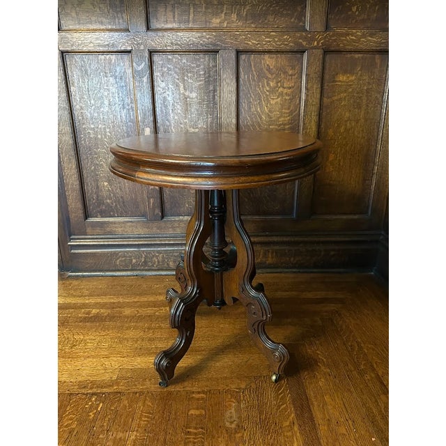 Late 19th Century Victorian Rococo Revival style carved walnut oval parlor/ side/game table measures 30.75' W x 23.5" D x...