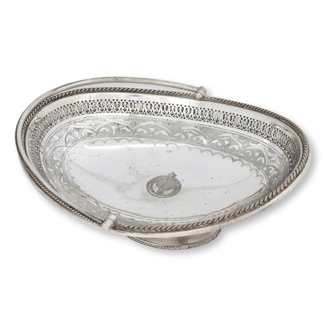 Late 19th century English silverplate basket with pierced gallery edge, engraved decoration, and a graceful swing handle....