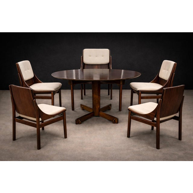 A sculptural and refined set of five dining chairs by Jorge Zalszupin, crafted in Brazilian jacaranda (rosewood) during...