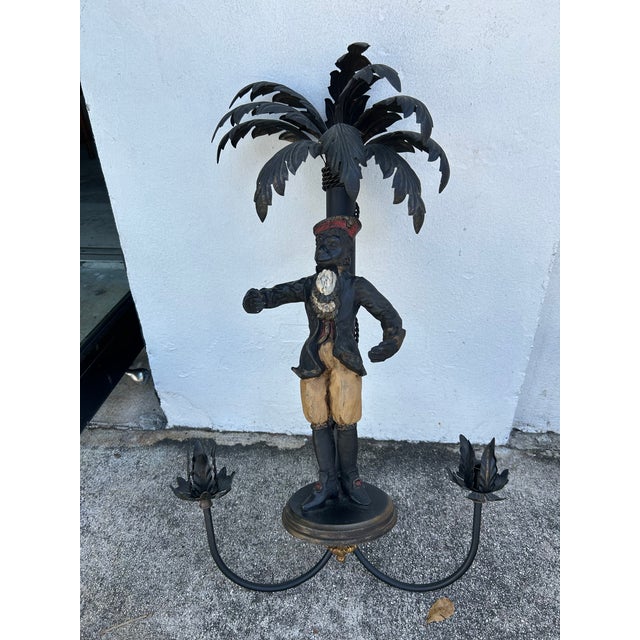 A whimsical pair of Italian two light Boho chic candle power wall sconces crafted in metal with palm trees over a well-...