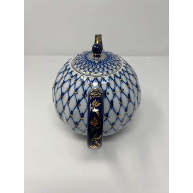 A timeless example of Russian porcelain artistry, this Imperial Porcelain Factory teapot features the iconic Cobalt Net...