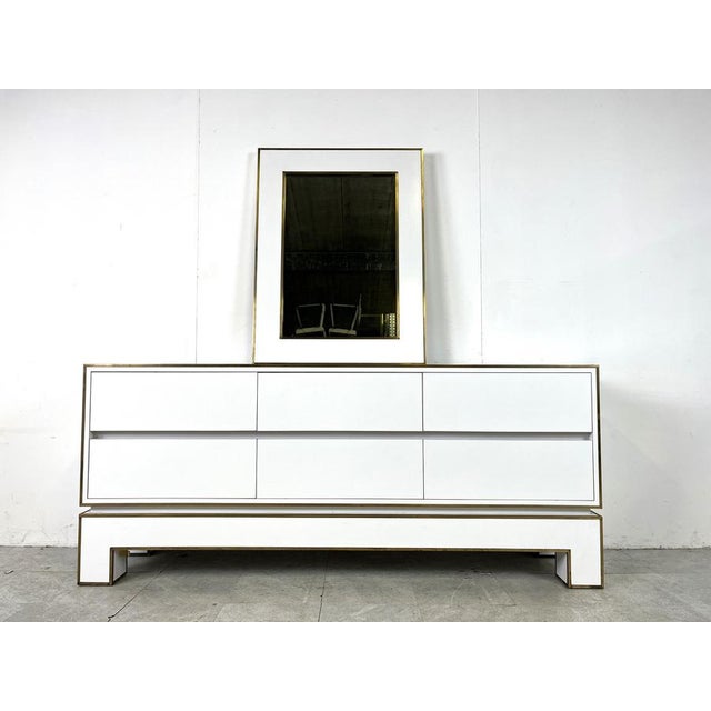 Mid century 6 drawer credenza by Alain Delon in white lacquer and brass. This exquisite credenza is pure quality, with a...