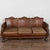 20th century vintage Danish three-seat sofa upholstered in brown leather. Decorative nail head trim and the camelback...