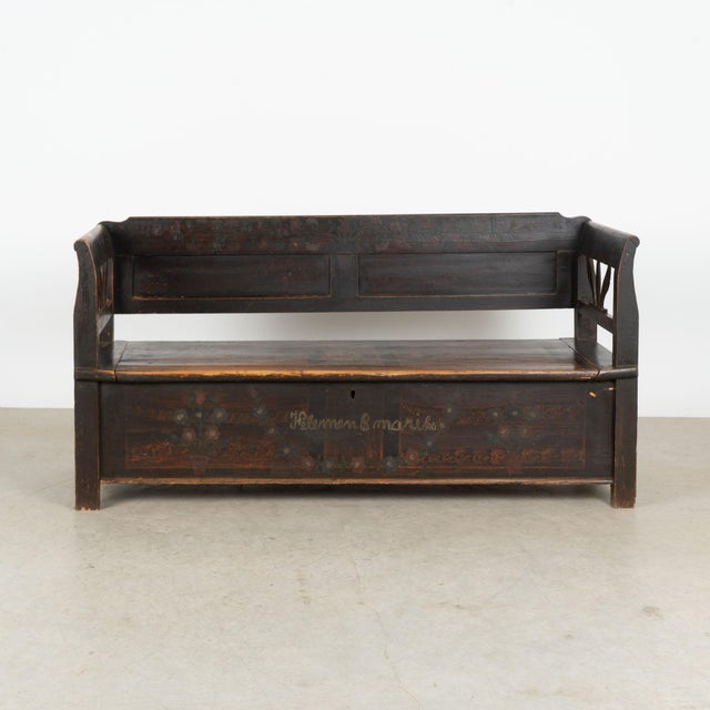 Hungarian storage bench, crafted in pine with its original hand-painted folk art finish. Dark brown faux wood painting...