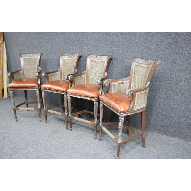 *20th century; caned back and sides with scroll arms, acanthus carvings on arms and crest rail, stretcher base, with metal...