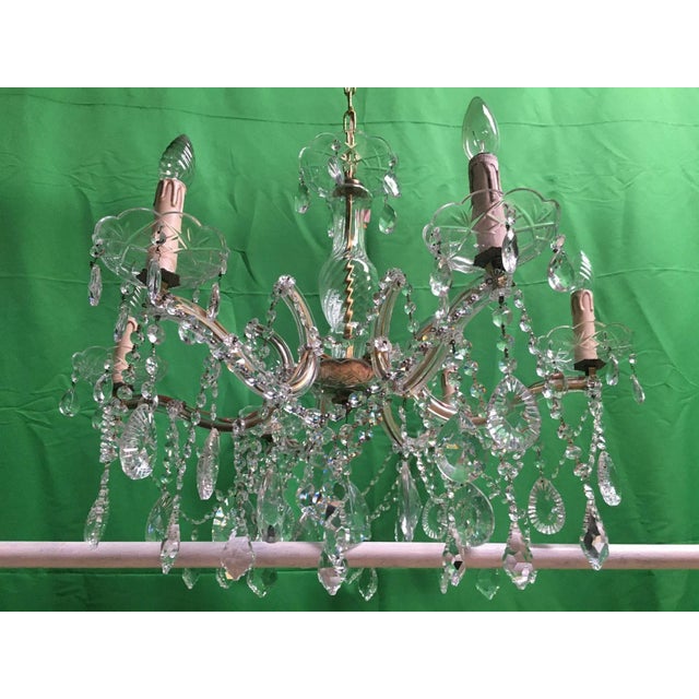 Maria Teresa Crystal Chandelier 1970s. It is made of crystal glass hand cut plates and pendants. The center of the...