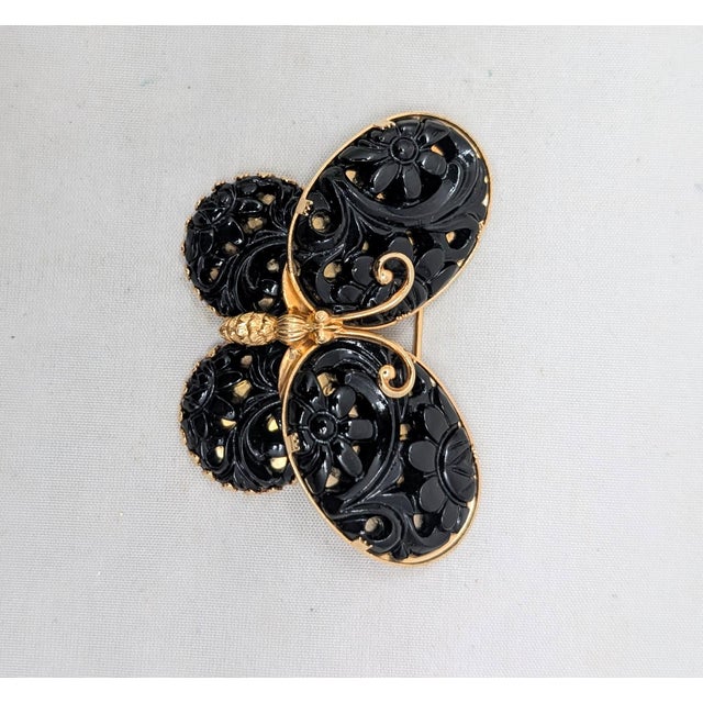 Rare 1960s goldtone 4 oval carved faux-onyx in the shape of a butterfly brooch. Marked "NAPIER" on the back. Measures: 1...