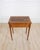 Made in France in the twentieth century, this small Louis XVI style side table is constructed in cherrywood, with a pull-...