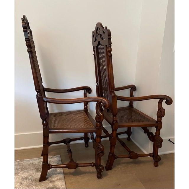 Pair of Large antique carved oak throne chairs. Cane back and cane seat. Carved edge arms and legs. Intricate high back...