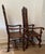 Pair of Large antique carved oak throne chairs. Cane back and cane seat. Carved edge arms and legs. Intricate high back...
