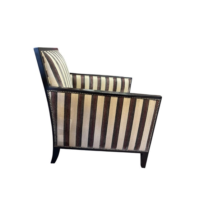 An elegant contemporary lounge chair featuring a sleek ebony-stained hardwood frame upholstered in sophisticated neutral...