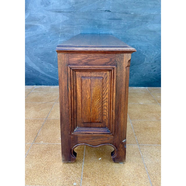 Spanish Renaissance Revival oak sideboard, 1930s Crafted in solid oak, this substantial piece features carved geometric...