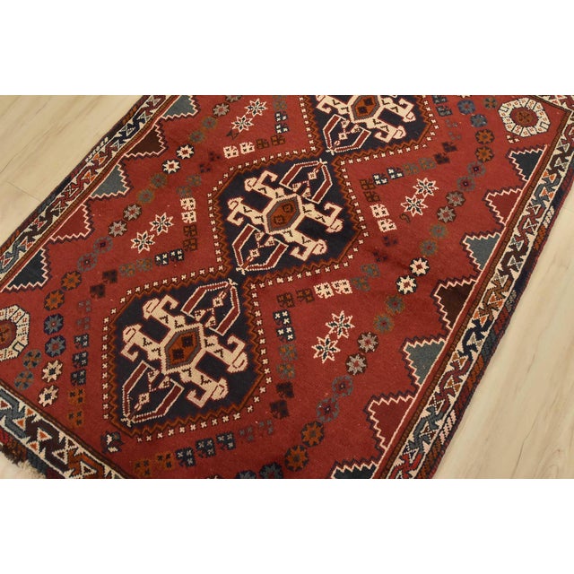 An authentic vintage tribal Shiraz rug hand-knotted with fine wool and natural dyes. This nomadic rug features geometric...