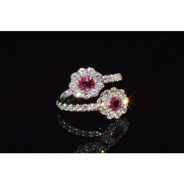 Top quality certified 18K solid white gold 2.08CTS diamond and ruby bypass halo ring. This elegant ring features two...