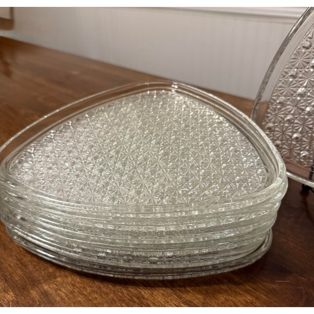 This is a set of seven snack plates featuring the “Daisy and Button” pattern by Indiana Glass Company manufactured in...