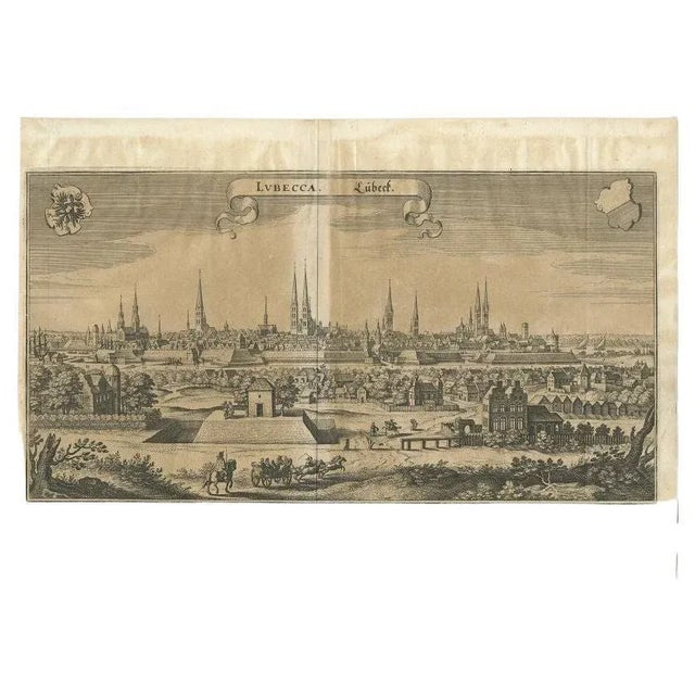 Antique print titled 'Lubecca, Lübeck'. A bird's eye view of Lubeck, the northern German city in Schleswig-Holstein. This...