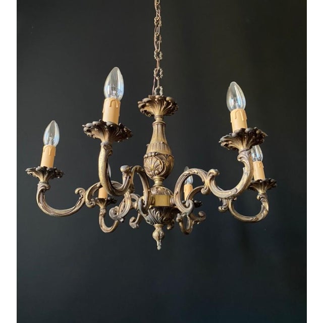 Luxurious antique chandelier. italy, 20th century. the chandelier is made of bronze. Decorated with brass elements....