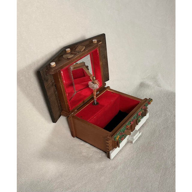 Vintage, designed to resemble a Swiss Chalet music jewelry box made of wood with dancing ballerina, circa 1960’s. Laurel...