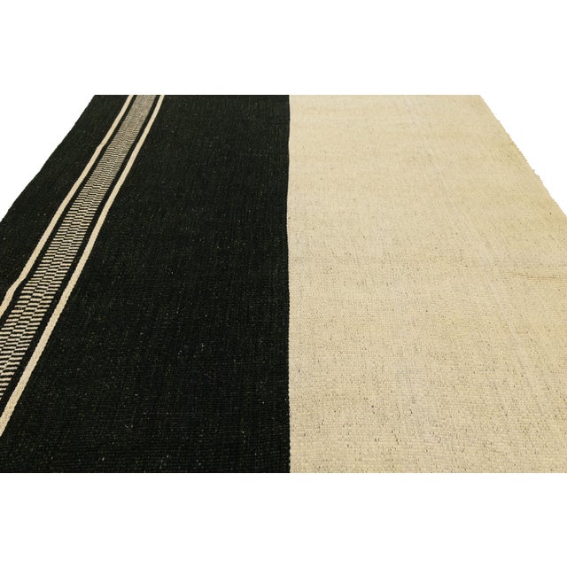 This striking Modern Kilim Style rug features a bold, asymmetrical color-block design that perfectly blends tribal...