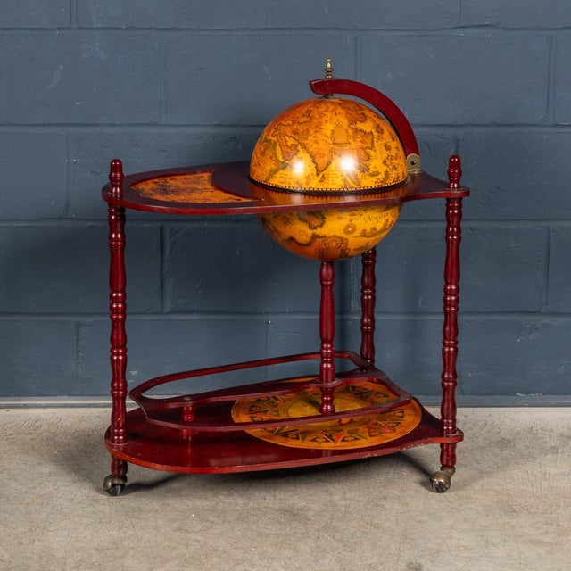 A decorative and highly functional Italian globe drinks trolley, dating to the second half of the 20th century. Combining...