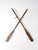 Pair of vintage wooden boat oars featuring weathered wood, long tapered blades, and beautifully aged finishes that...