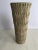 A single round art pottery vase or vessel with textured sides and flared top.