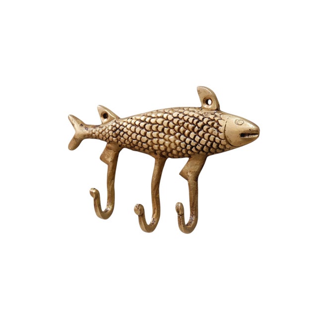 A pair of brass fish wall fixtures with three hooks. A central bar is cast in the oval shape of a fish, complete with...