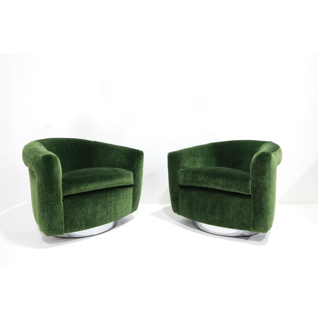 A beautiful set of two Milo Baughman tilt/swivels newly upholstered in a high-quality plush green mohair. Chromed bases....