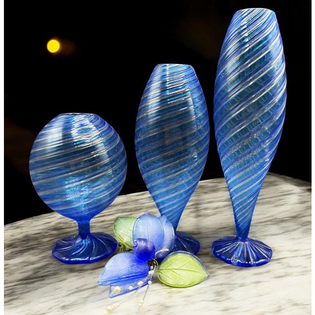 This set of three Murano vases represents a fascinating expression of glass art, featuring a splendid design in blue...