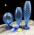 This set of three Murano vases represents a fascinating expression of glass art, featuring a splendid design in blue...