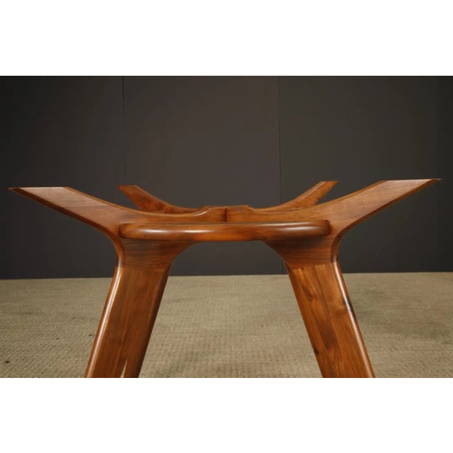 A striking example of Adrian Pearsall’s sculptural design language, this 'Compass' dining table was produced by Craft...