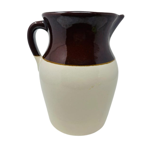 A beautiful piece of American history, this 10-inch stoneware pitcher features the iconic "chocolate and cream" two-tone...