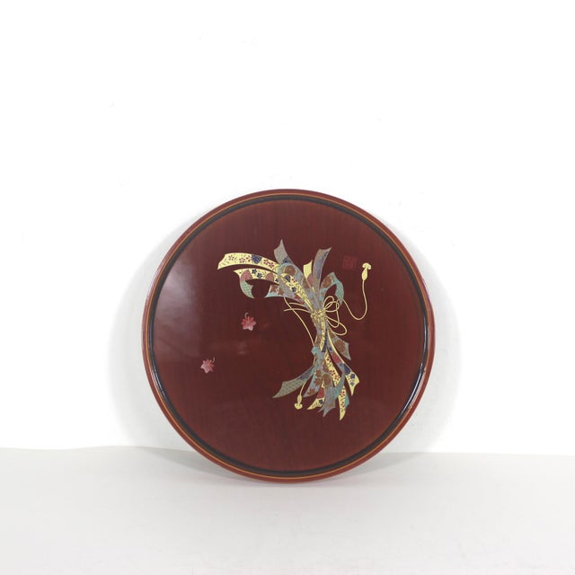 Gorgeous, vintage lacquered wood tray from Japan in a round shape with a raised edge. The beutiful wood grain shows...
