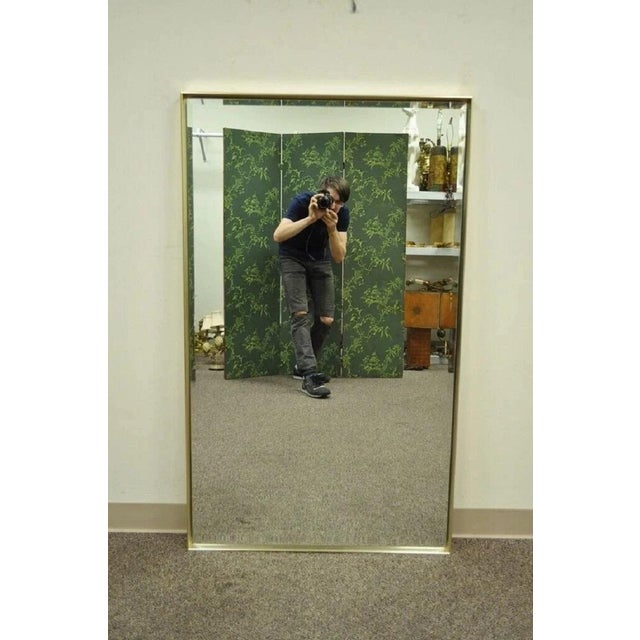 Vintage Mid Century Modern Paul McCobb Style Brass Tone Beveled Glass Mirror. Item features brass tone metal finish,...