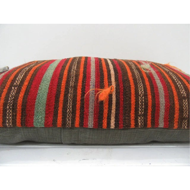 This is a pillow cover made from a vintage kilim rug. The piece was properly washed and ready to use. Pillow inserts not...