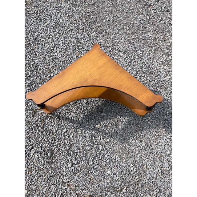 An unusual two-tiered tri-angular shaped corner table very much in the style of Maison Jansen. Of maple with a lovely...